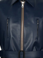 Close-up of a navy blue leather jacket with a zipper and belt.