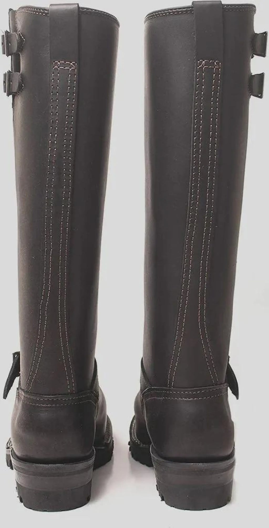 Pair of black knee-high Double Strap Leather Biker Boots on a white background