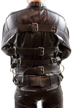 Black leather harness worn by a person on a white background